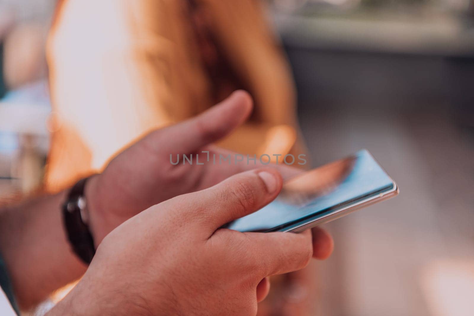 Closeup photo of businessman hand utilizes his smartphone outdoors, showcasing the seamless integration of technology and mobility in modern professional life