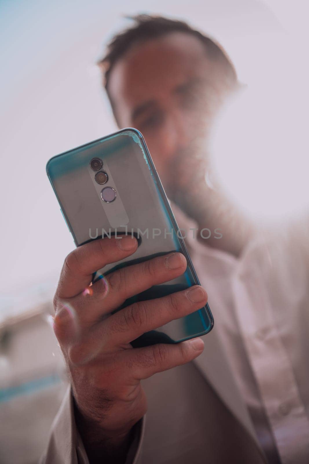 A businessman using his smartphone outdoors, showcasing the seamless integration of technology and mobility in modern professional life