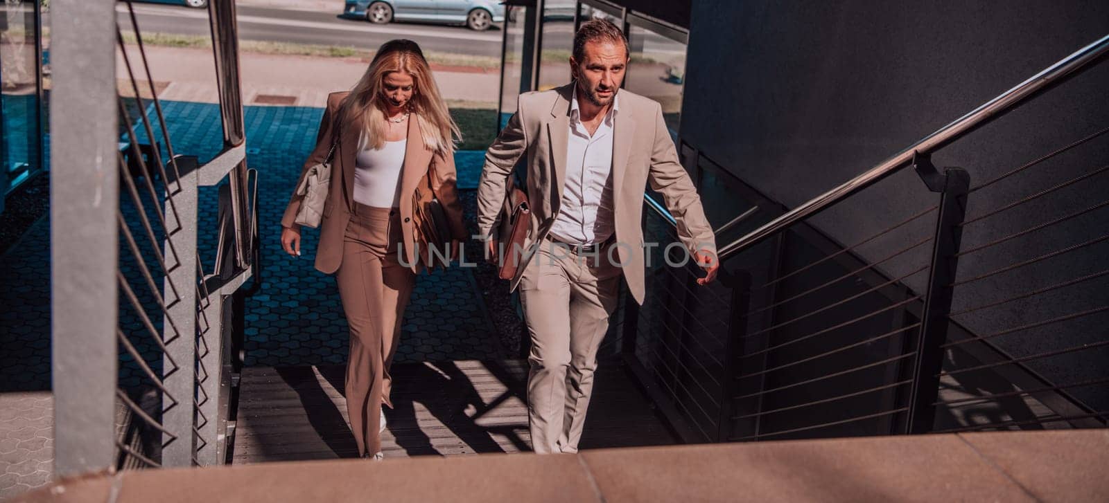 Modern business couple after a long day's work, walking together towards the comfort of their home, embodying the perfect blend of professional success and personal contentment