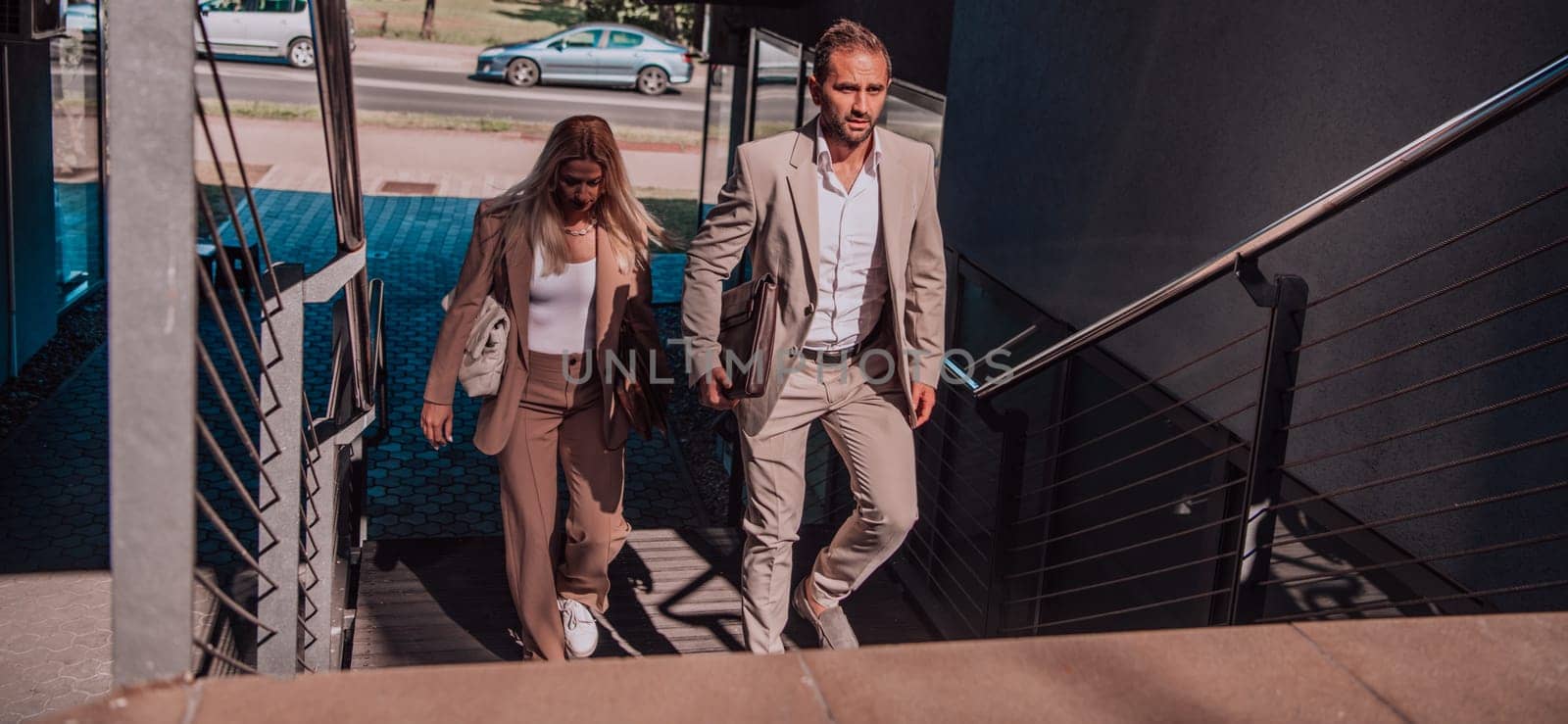 Modern business couple after a long day's work, walking together towards the comfort of their home, embodying the perfect blend of professional success and personal contentment