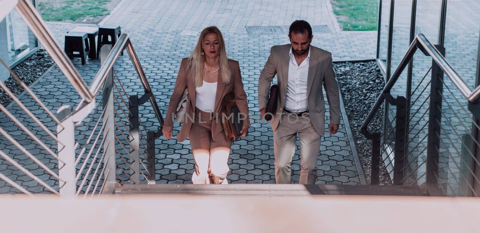 Modern business couple after a long day's work, walking together towards the comfort of their home, embodying the perfect blend of professional success and personal contentment