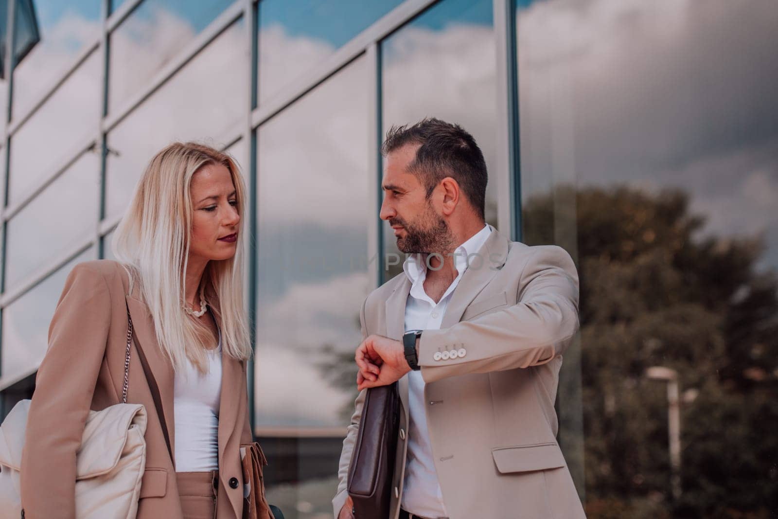 Modern business couple after a long day's work, walking together towards the comfort of their home, embodying the perfect blend of professional success and personal contentment. by dotshock