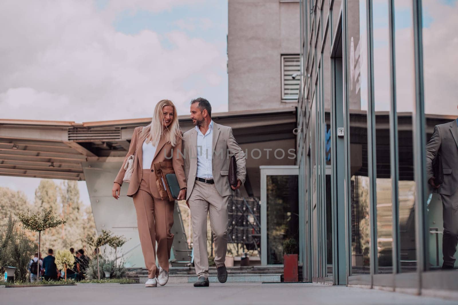 Modern business couple after a long day's work, walking together towards the comfort of their home, embodying the perfect blend of professional success and personal contentment