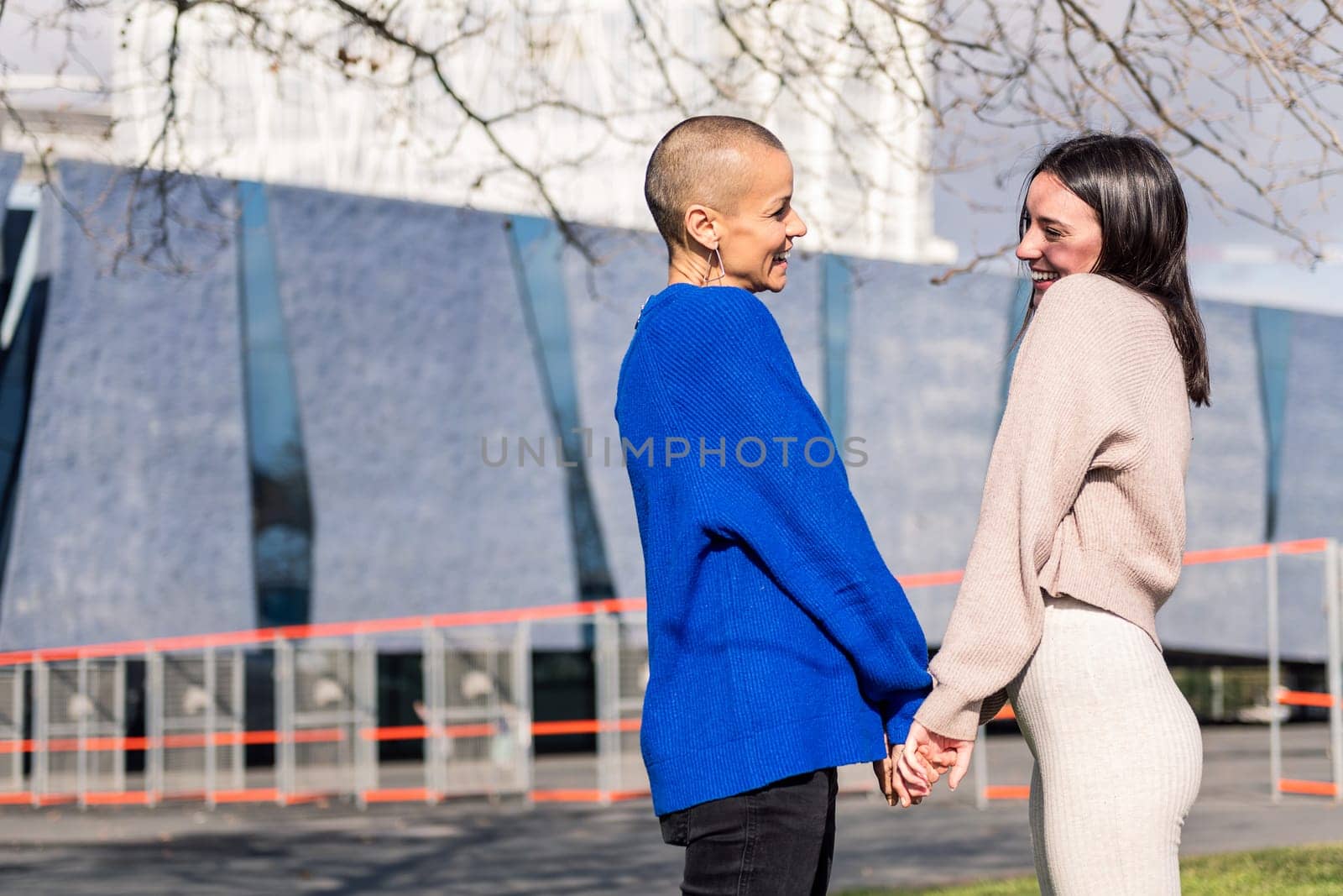 lesbian couple of two women smiling happy looking in love in to the eyes, concept of freedom and love between people of the same sex