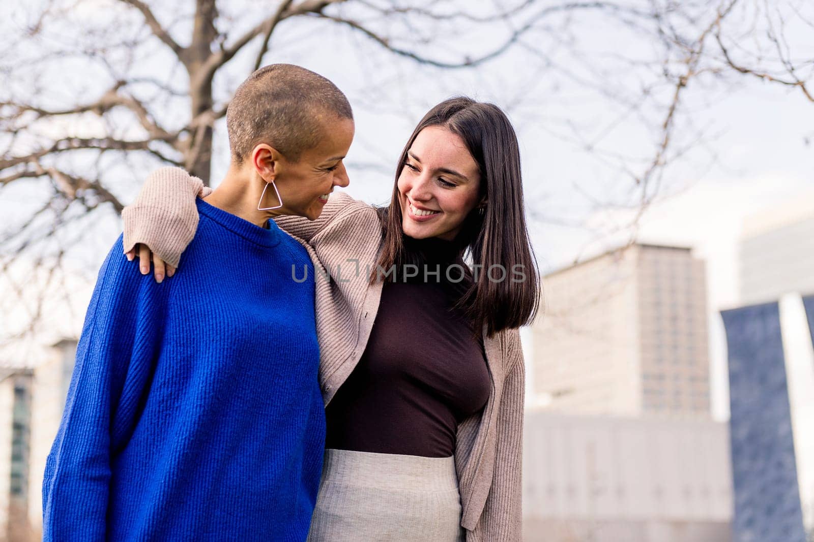 lesbian couple of two young women smiling happy taking a romantic walk, concept of freedom and love between people of the same sex