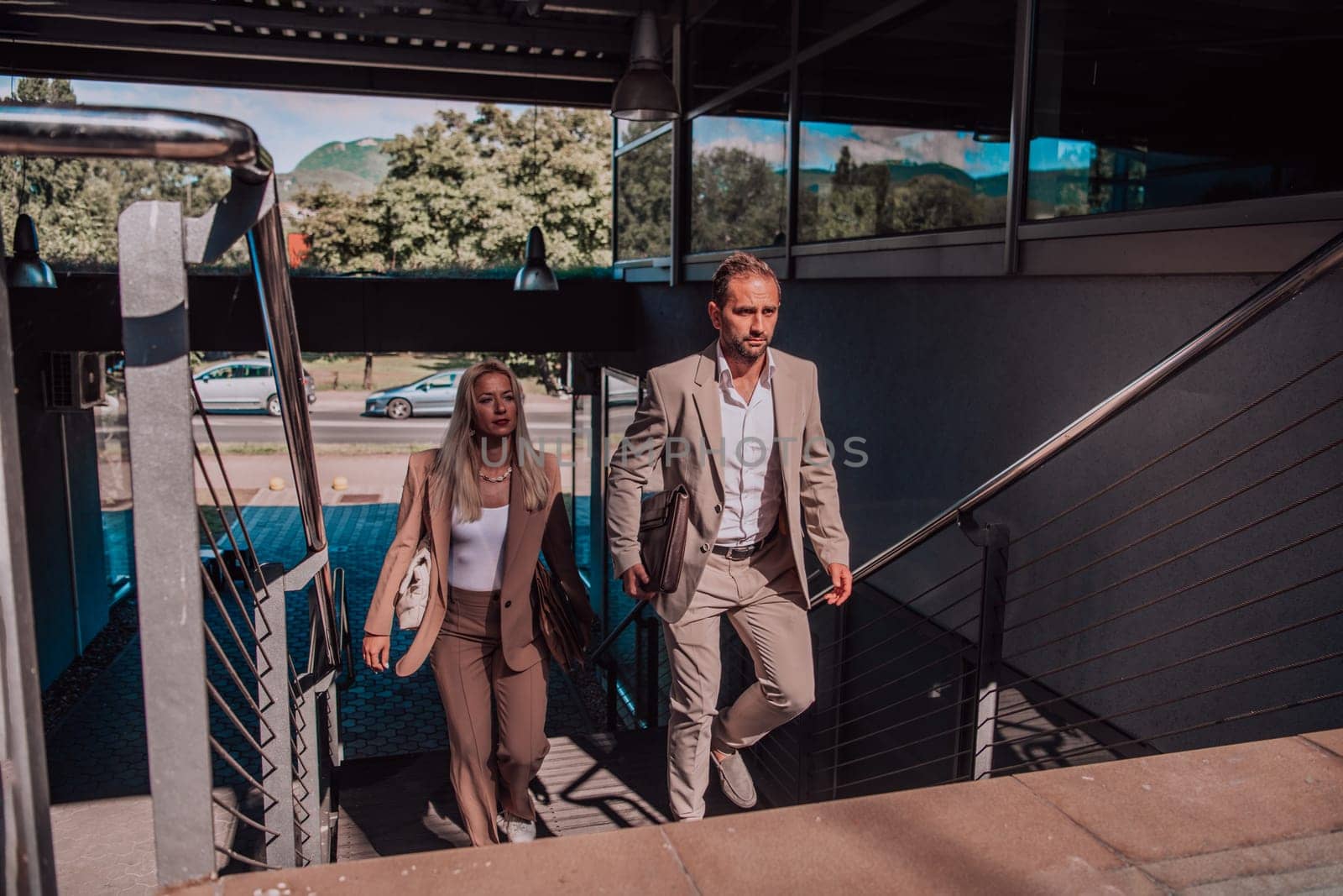 Modern business couple after a long day's work, walking together towards the comfort of their home, embodying the perfect blend of professional success and personal contentment