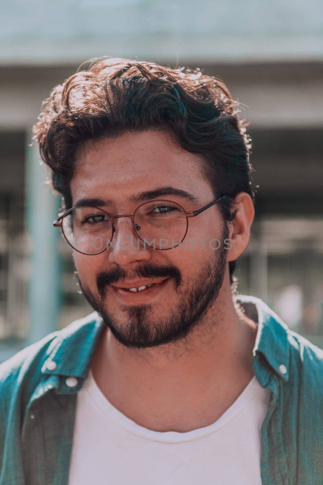 A portrait of a modern man, exuding confidence and style, against an outdoor backdrop, showcasing his charisma and fashionable demeanor