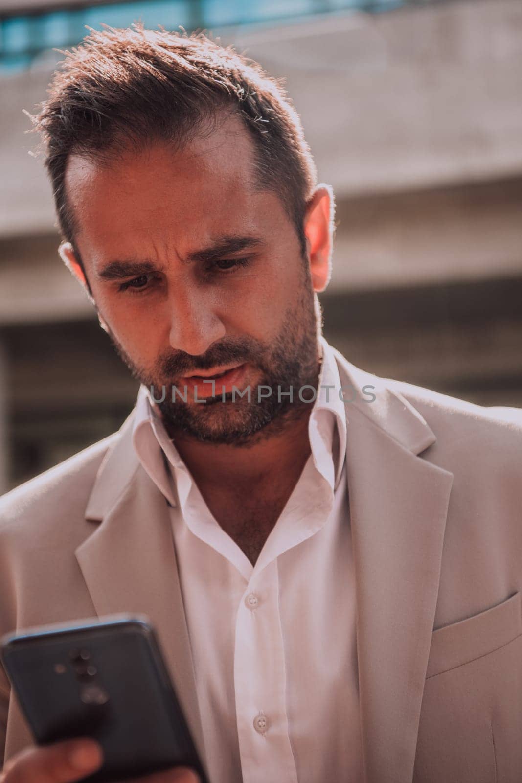 A businessman using his smartphone outdoors, showcasing the seamless integration of technology and mobility in modern professional life