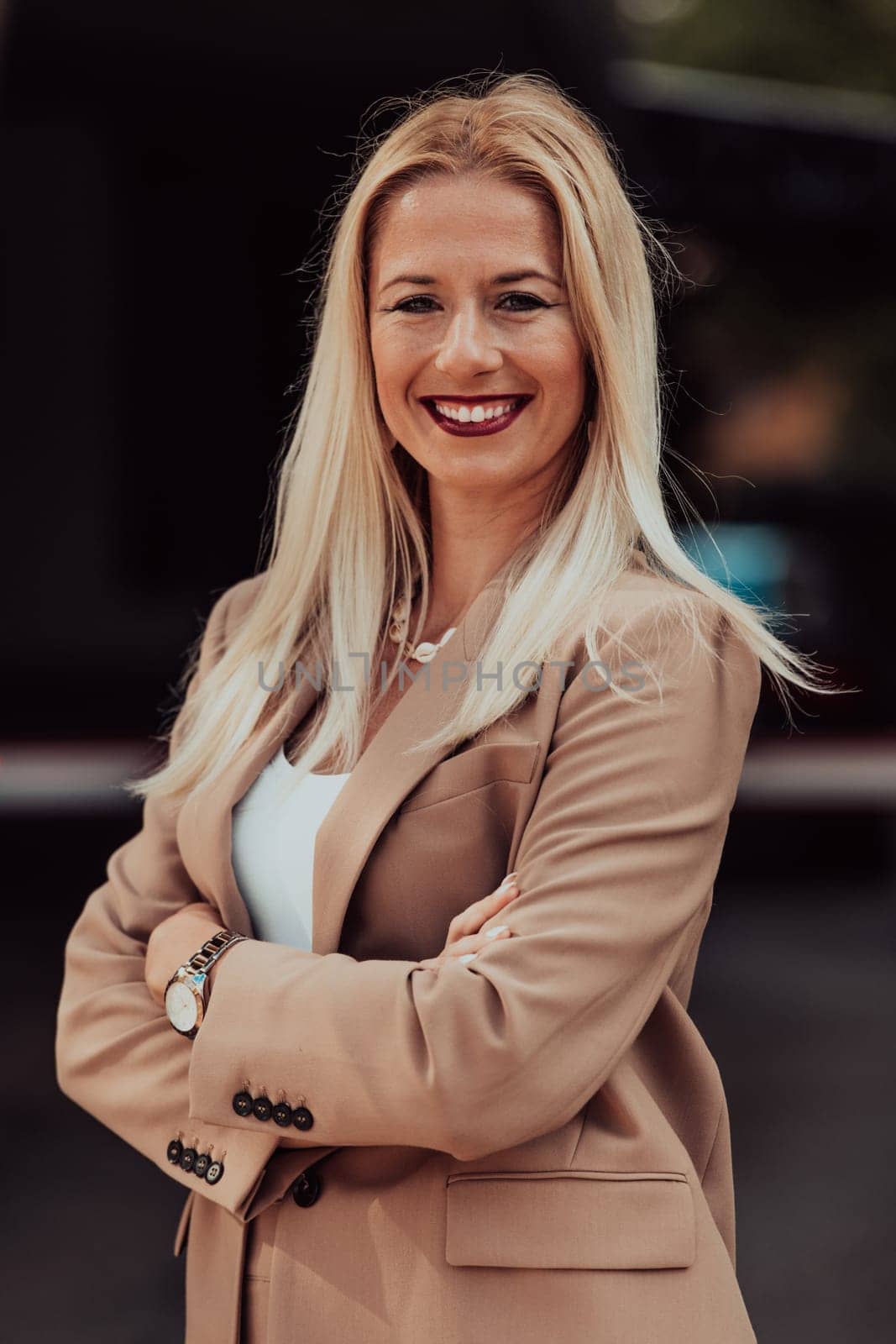 A powerful portrait of a businesswoman, standing confidently with her arms crossed, representing the determination of the female gender and embodying strength and success.