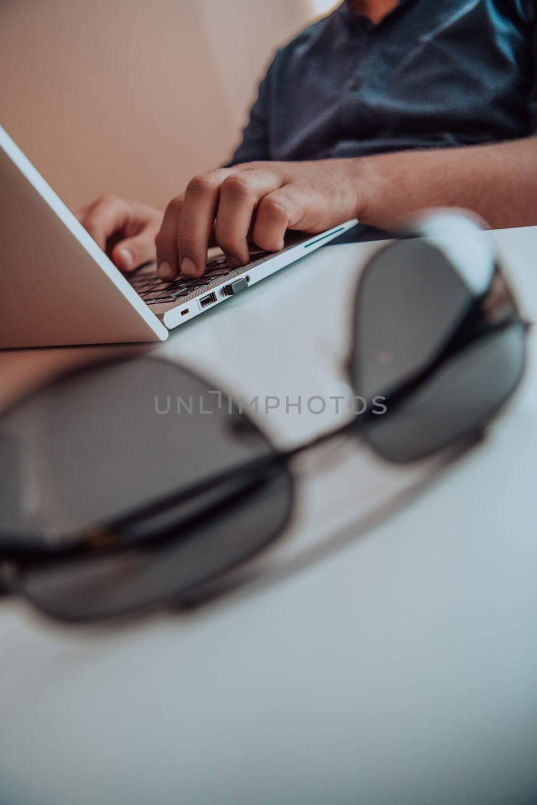 Close-up photo of a programmer typing on a laptop. High quality photo