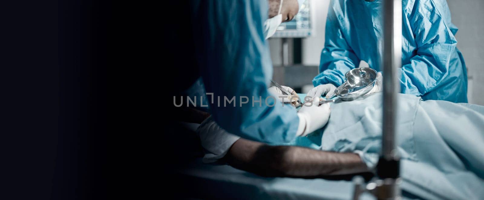 Surgery, teamwork and doctors in a hospital for an emergency life saving operation on a critical patient. Doctor, nurse and medical with a medicine surgeon group working in a clinic operating room by YuriArcurs