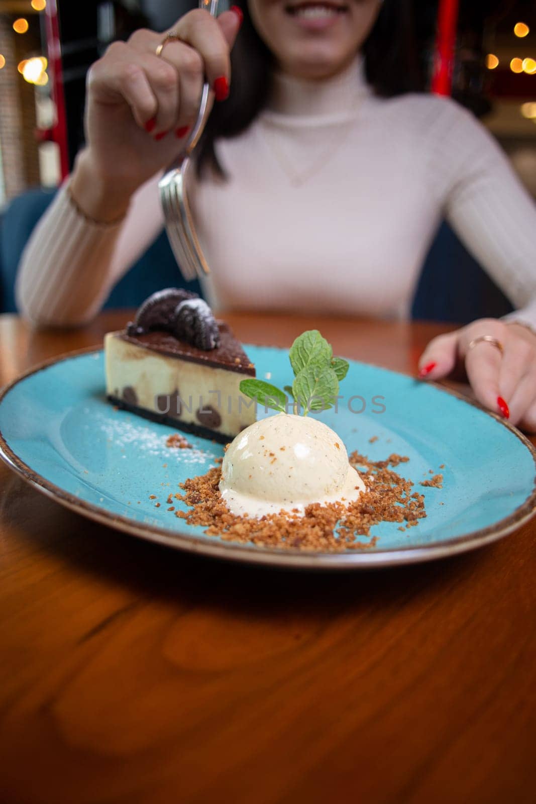 a girl without a face eats dessert in a cafe by Pukhovskiy