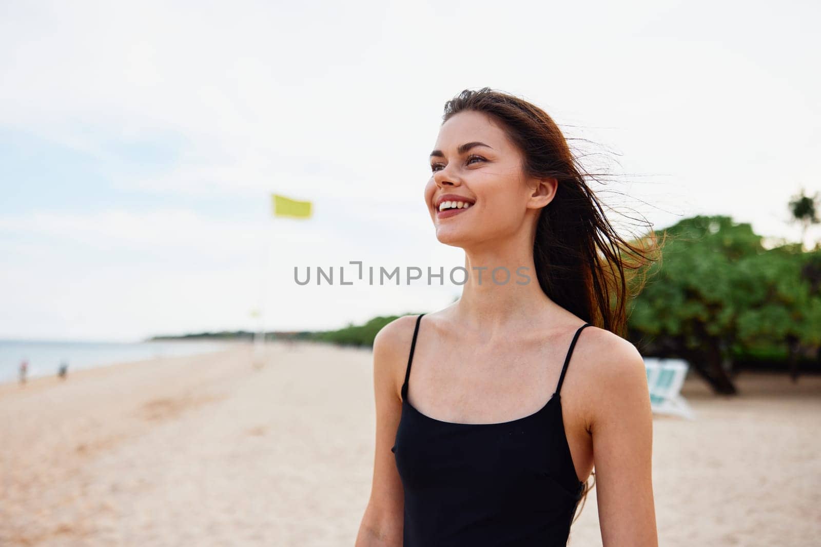 woman beach coast adult ocean vacation smile sun sea smiling sunlight carefree walking walk nature leisure sand young summer enjoyment happy