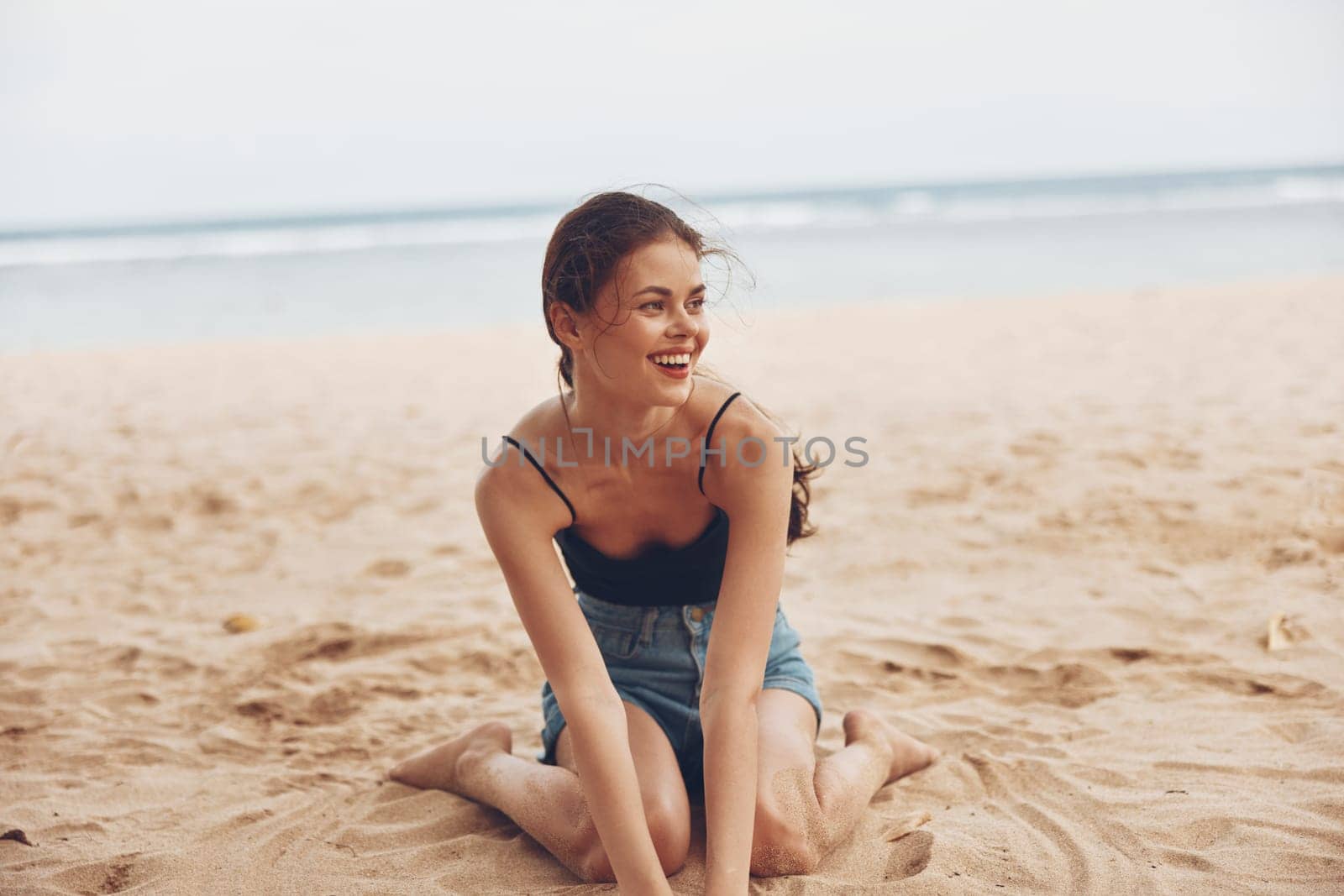 nature woman freedom young travel vacation summer sexy sea outdoor smile long sitting back water alone tropical person model sand beach view hair