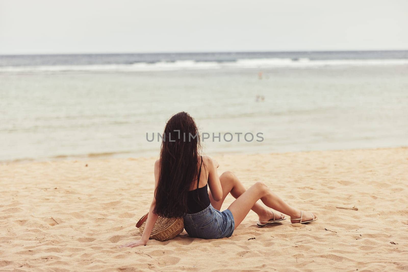 woman beautiful alone young relax smile freedom person sea sexy bali ocean beach travel nature vacation sun sand sitting lifestyle caucasian