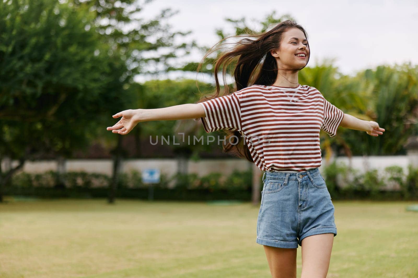 smiling woman walk happiness nature beautiful t-shirt park summer freedom lifestyle by SHOTPRIME