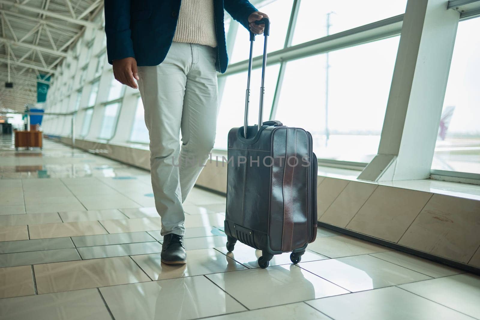 Airport legs, travel and man walking to airplane, flight booking or transportation for corporate trip. Luggage suitcase, plane departure or African businessman on holiday, vacation or global journey.
