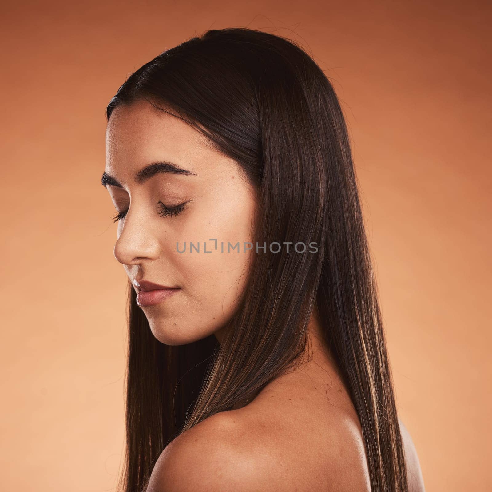 Face, beauty and skincare with a model woman in studio on a beige background for natural care or skin. Cosmetics, wellness and treatment with an attractive young female posing to promote a product by YuriArcurs