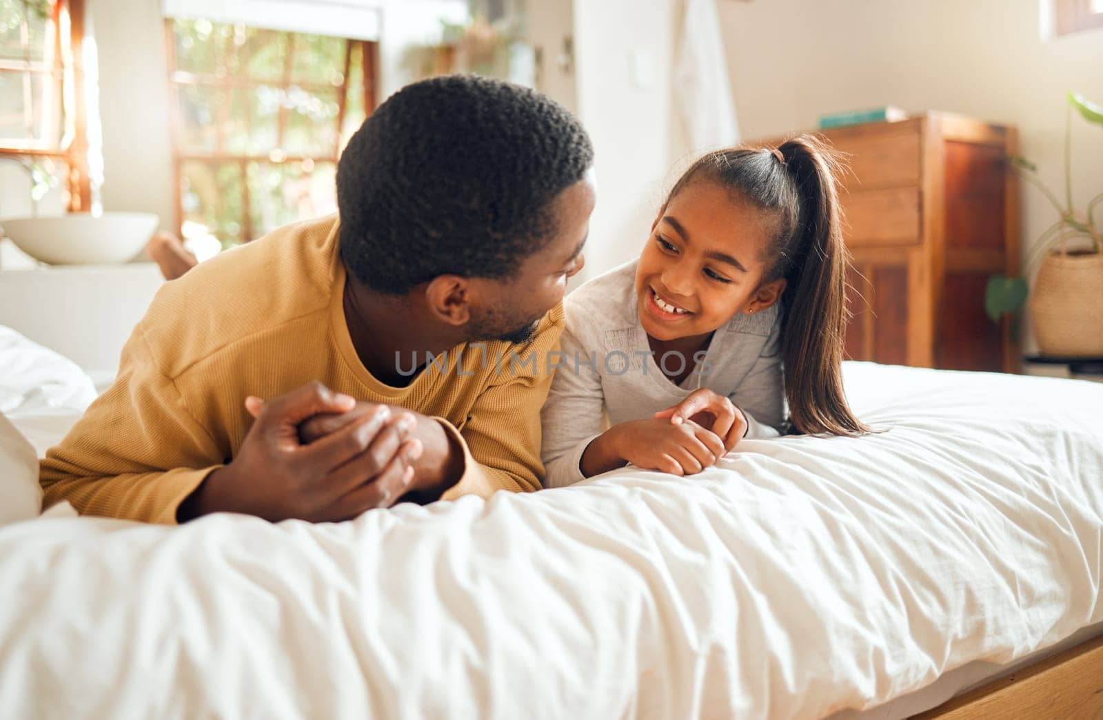 Family, father and girl kid talking, spending quality time together with love and care, relax in bedroom at home. Black man, child and happy people, communication and relationship with childhood.