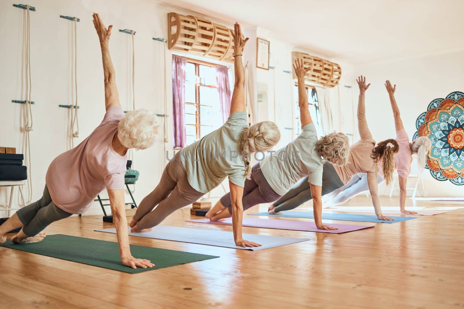 Yoga, class and group for elderly woman in health, fitness or zen meditation on gym floor. Workout, women and stretching for wellness, peace or calm balance exercise in mindfulness training together by YuriArcurs
