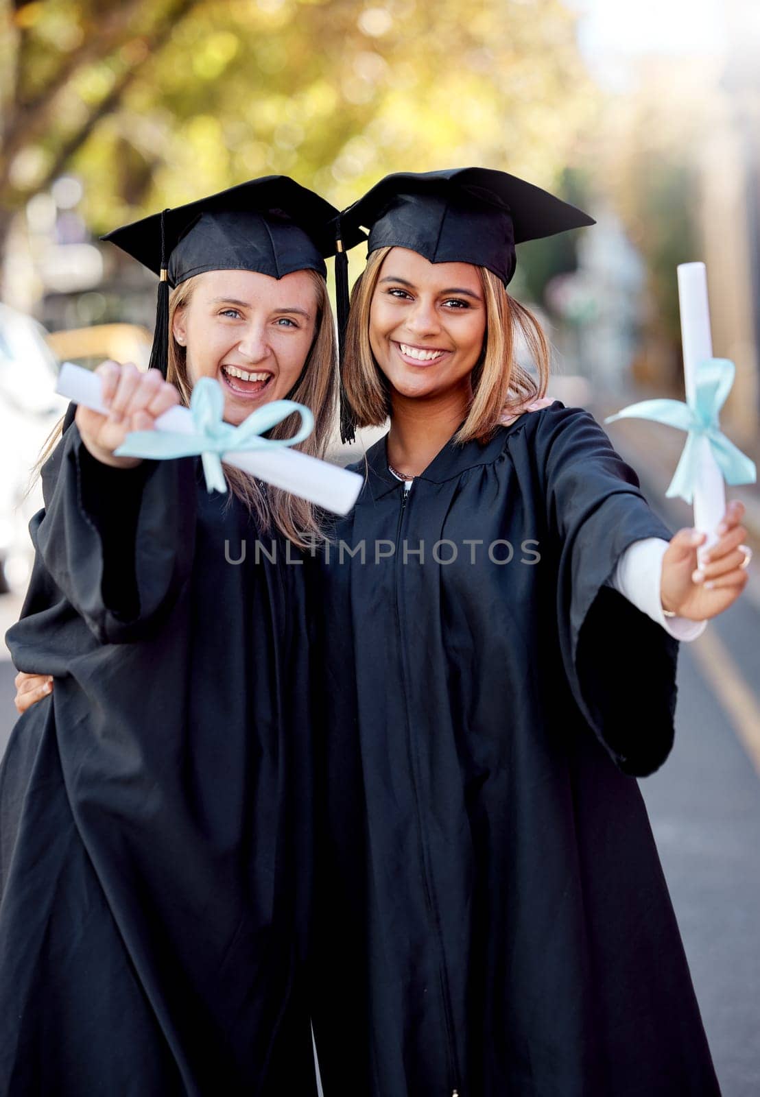 Graduation, education and portrait of friends with degree for academic success at university campus. Certificate, achievement and happy young women students with college diploma or scroll to graduate by YuriArcurs