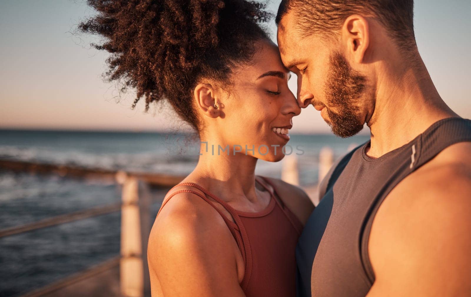 Black couple, smile and hug with forehead by beach embracing relationship, compassion or love and care. Happy man and woman touching heads smiling in happiness for support, trust or romance in nature by YuriArcurs