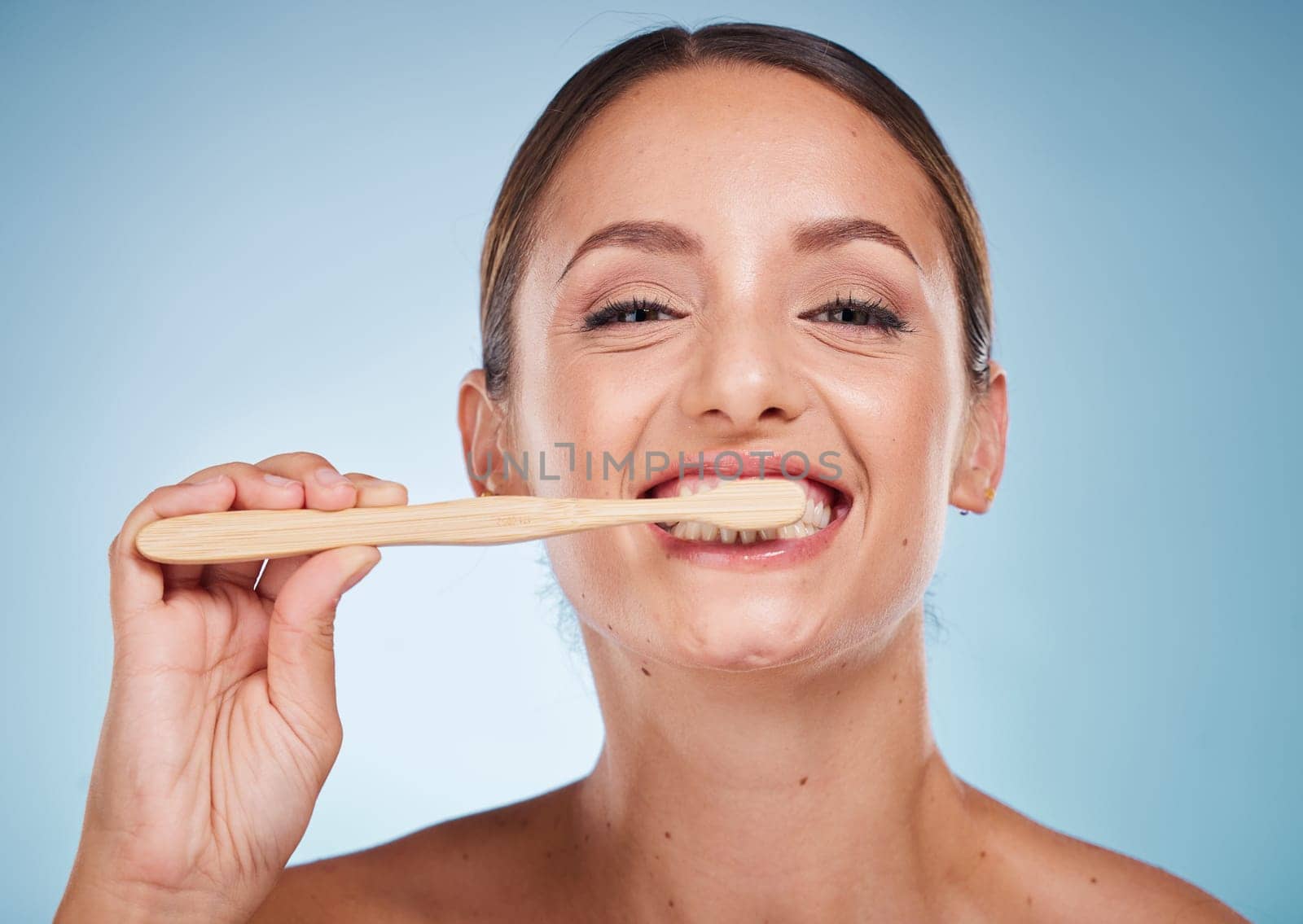 Brushing teeth, dental and woman with toothbrush for teeth whitening and beauty, oral health and fresh breath with studio background. Mouth wellness, Invisalign portrait and clean with bamboo brush. by YuriArcurs