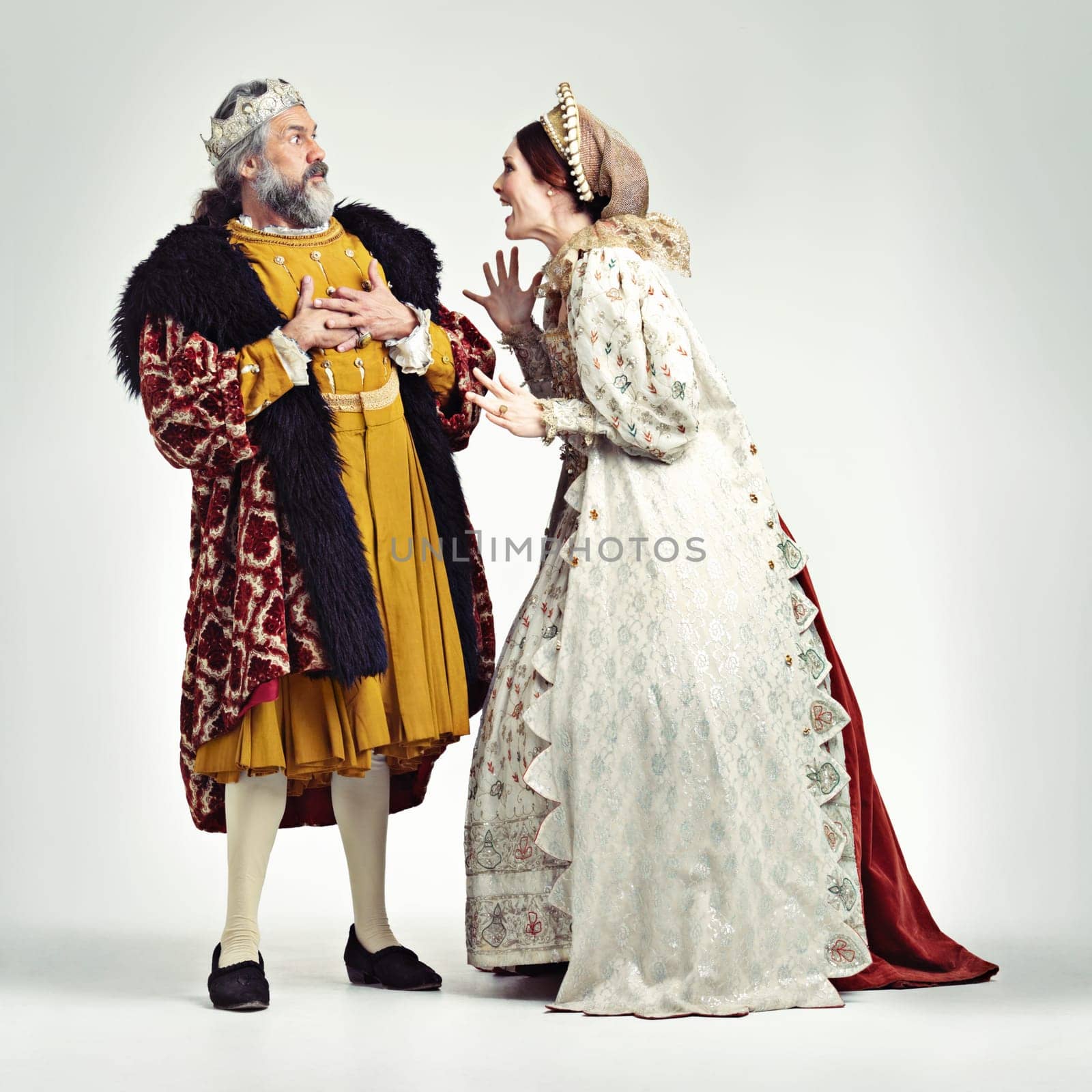 Argue, medieval and king with queen on a white background for argument, anger and frustrated fight. History, theatre and royal couple in vintage, renaissance and history cosplay isolated in studio.