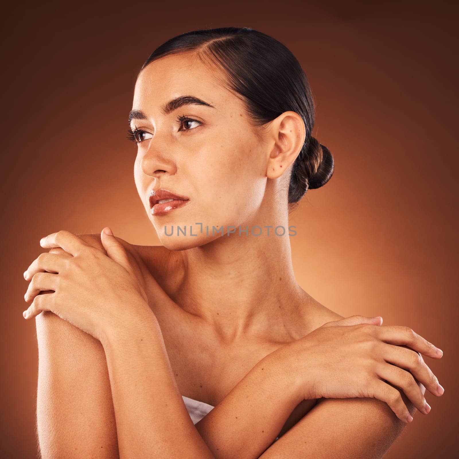 Beauty, skincare and face makeup, woman with cosmetics, serious face and luxury product and hair care. Health, wellness and skin care of cool beautiful girl from Mexico in brown studio background by YuriArcurs