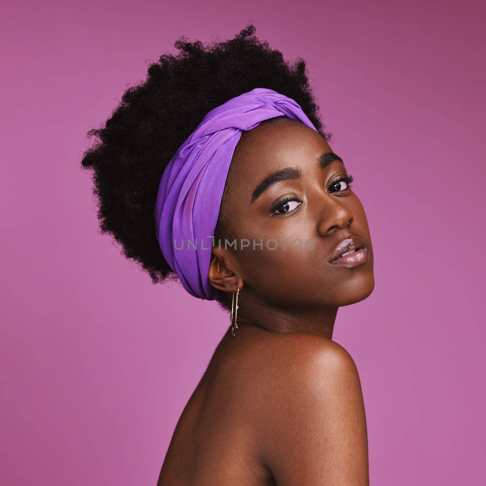 Portrait, beauty and aesthetic with a model black woman on a pink background in studio for natural skincare. Face, hair or headband with an attractive young female posing to promote cosmetics.