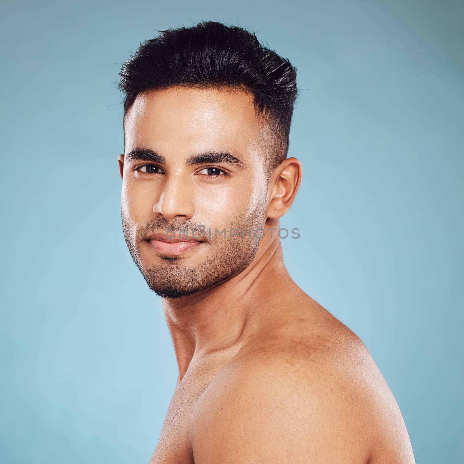 Health skincare and a portrait of man, topless with healthy skin and natural glow after detox facial and smile on face in India. Male body care, fitness and self love in studio with blue background