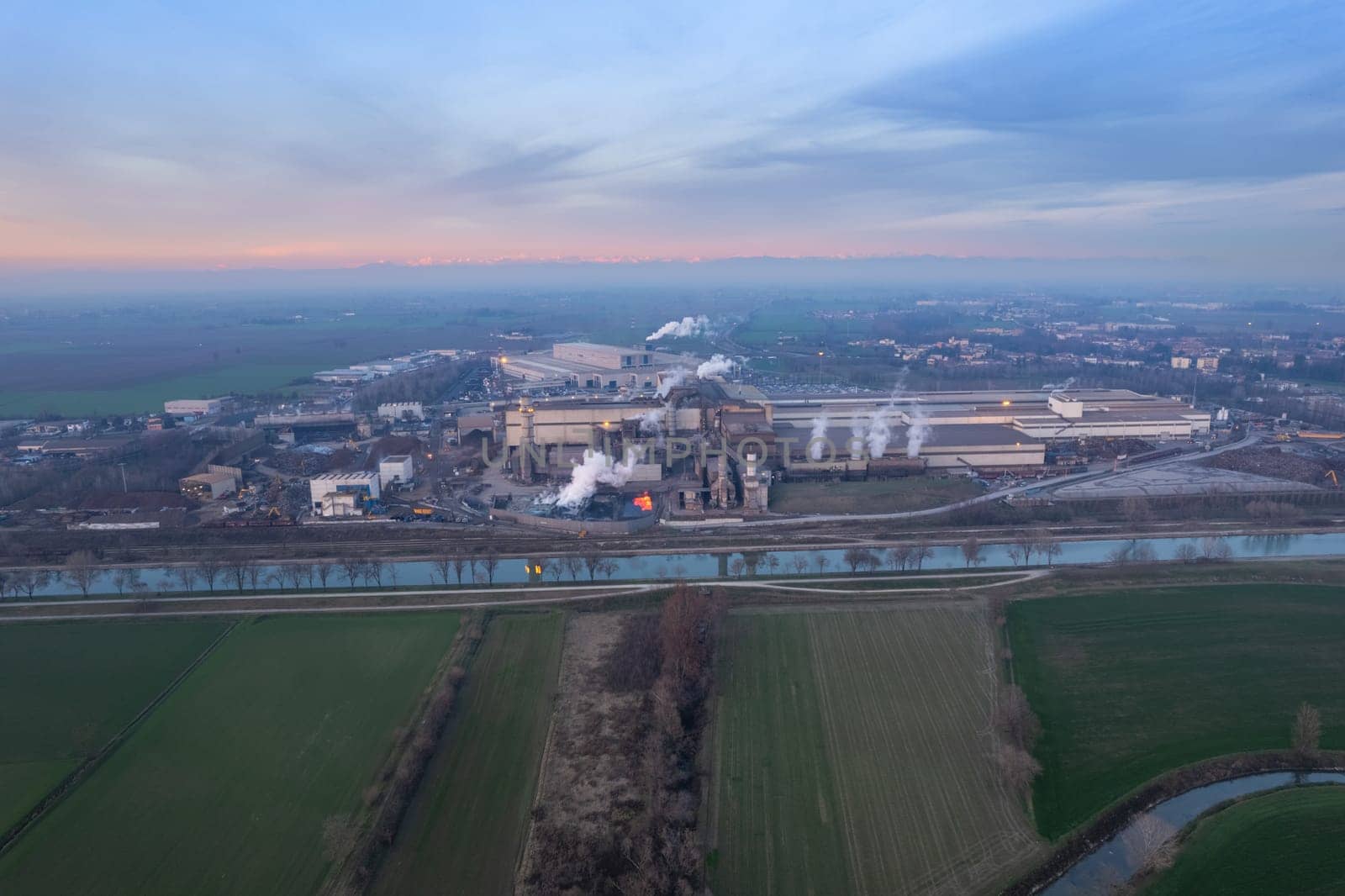 Cremona, Italy - January 2022 Drone aerial view of Arvedi working steel plant at dawn, industrial zone in Spinadesco, Cremona, Lombardy Italy