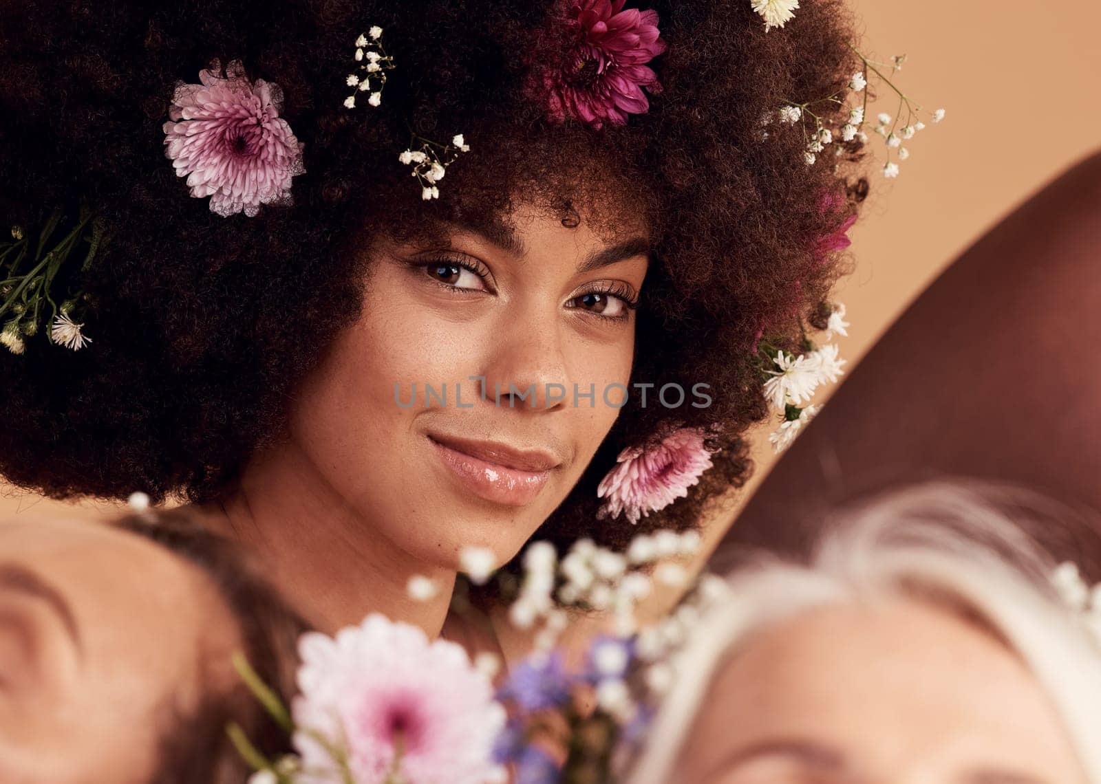 Black woman, flowers and smile for beauty portrait in studio for skincare wellness, luxury makeup aesthetic and cosmetics hair care. Spring floral art, happiness and facial care or dermatology glow.