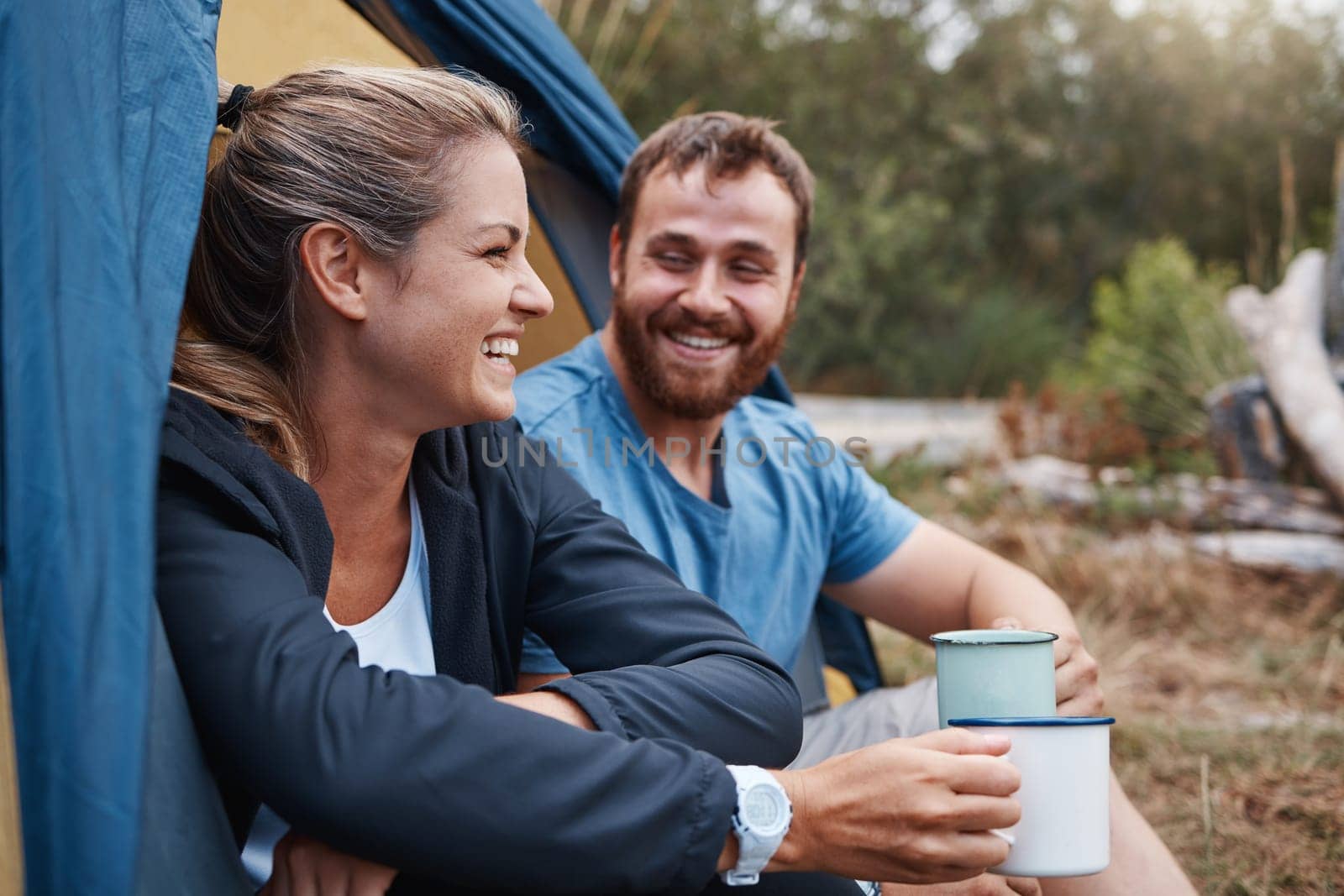 Couple, bonding or drinking coffee in camping tent in nature earth environment, Canada woods or sustainability forest. Smile, happy woman or laughing man with tea on romance love date in countryside.