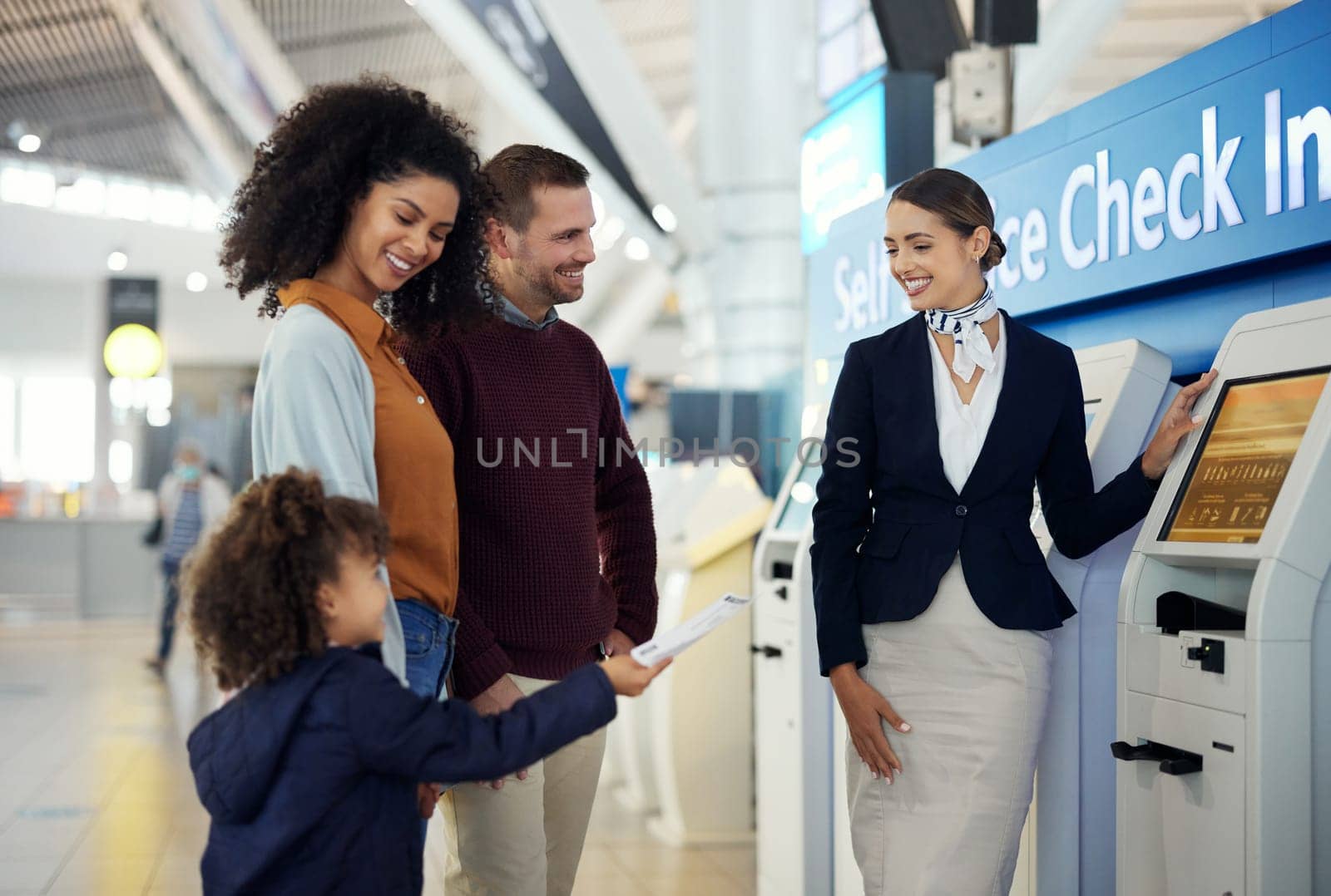 Woman, services agent and family at airport by self service check in station for information, help or FAQ. Happy female passenger assistant helping travelers register or book airline flight ticket by YuriArcurs