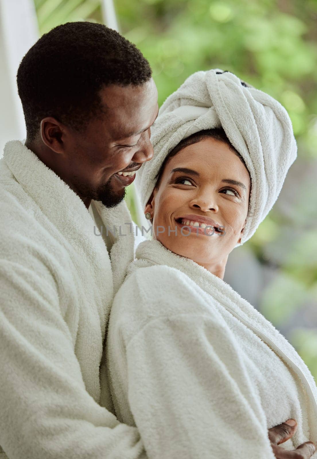 Spa, love and relax with a black couple in a health center or luxury resort for romance and wellness. Vitality, rest and relaxation with a man and woman at a lodge for a romantic weekend getaway by YuriArcurs