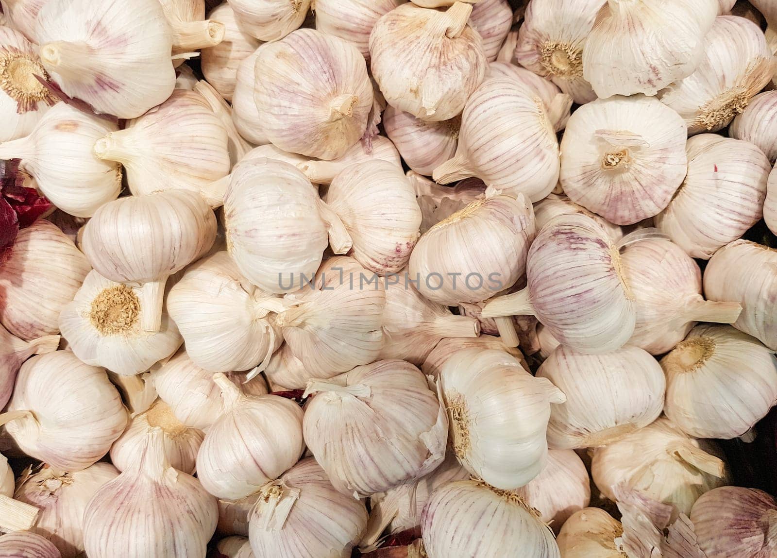close-up of a garlic background in a vegetable market, lots of garlic heads.
