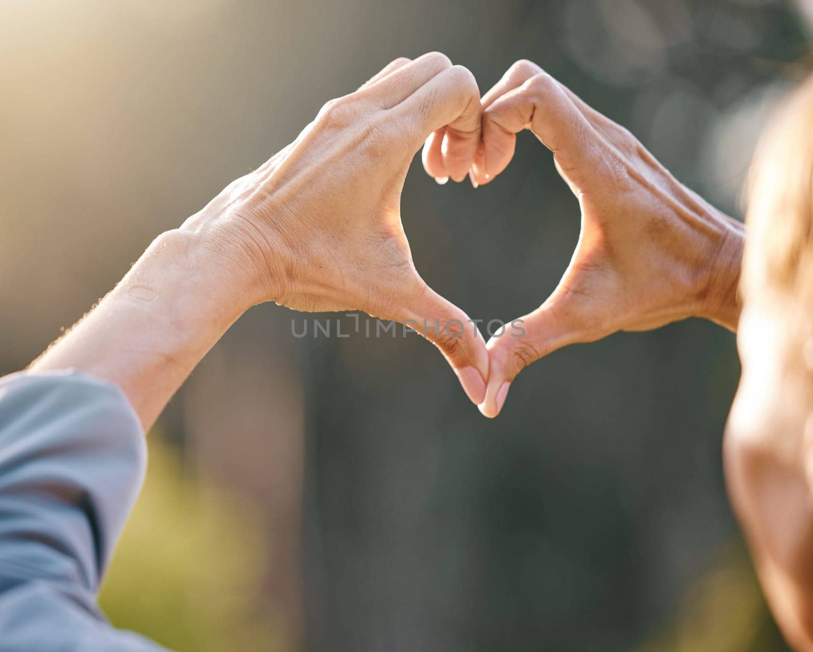 Hands, heart and people with a love sign in nature while on adventure, vacation or trip together. Freedom, romance and hand romantic gesture with shape emoji in the park, forest or woods on holiday. by YuriArcurs