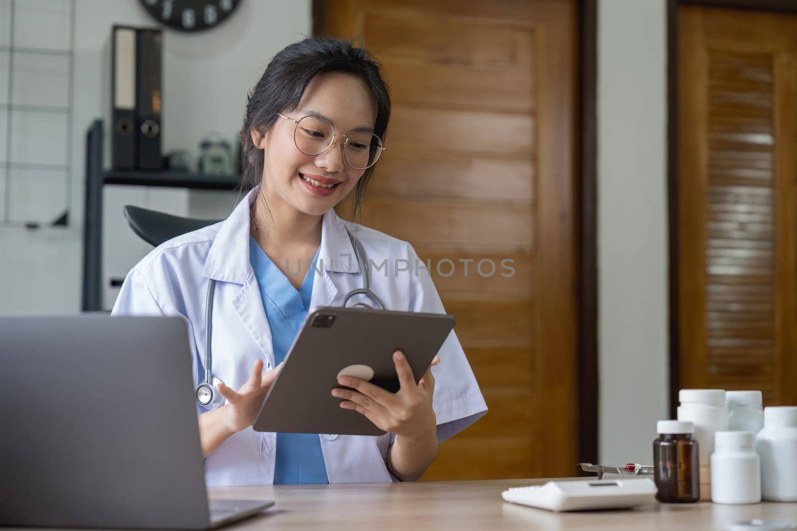 Doctor pointing at digital computer tablet screen, sharing health tests laboratory results to serious female patient or explaining medical insurance benefits at meeting in clinic.