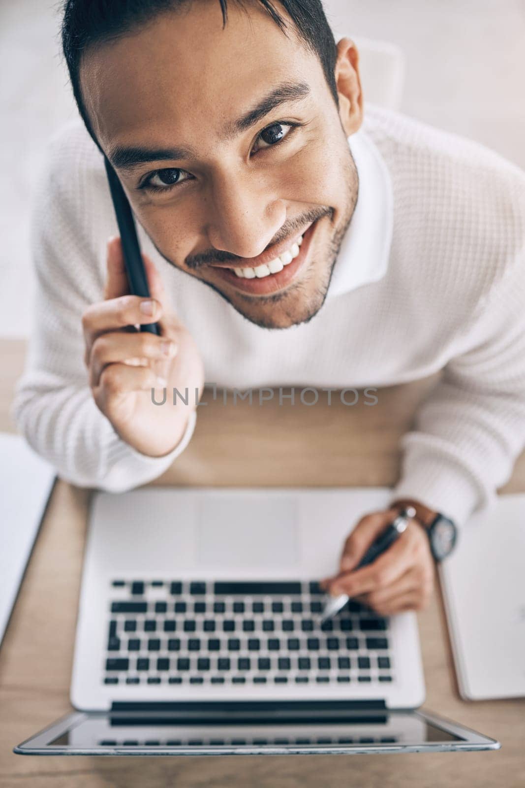 Laptop, phone call and business man with startup planning, marketing copywriting and online productivity at office desk. Networking, technology and sales businessman communication from above portrait.
