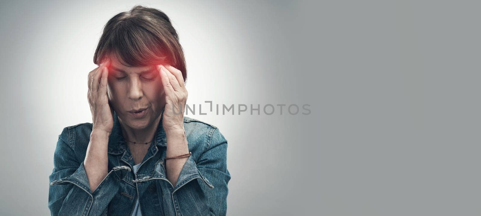 Headache, pain and hurt woman with a migraine in due to depression, frustrated and anxiety in mockup space. Red, overlay and discomfort by a female feeling sick isolated in a studio gray background by YuriArcurs