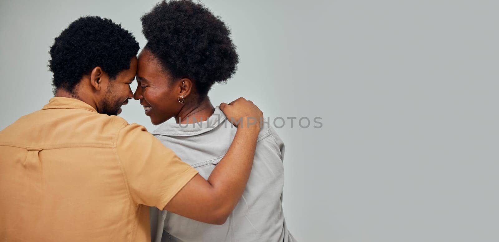Mockup, wall background or black couple love bonding, hugging or enjoying quality time together at home. Back view, forehead or African man with a happy woman hug while relaxing in apartment or house by YuriArcurs