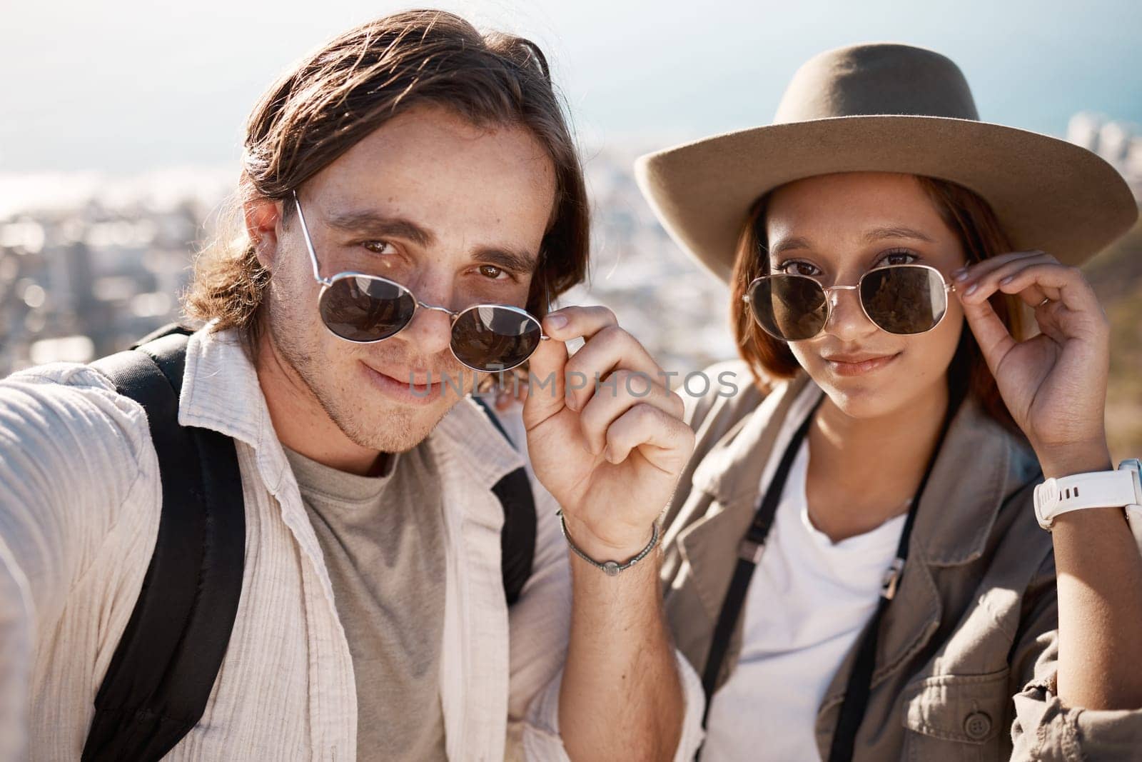 Selfie, hiking and couple on vacation, adventure and wellness with fitness, romance and cheerful. Portrait, romantic man and woman with sunglasses, hikers or journey for summer holiday, break or love.