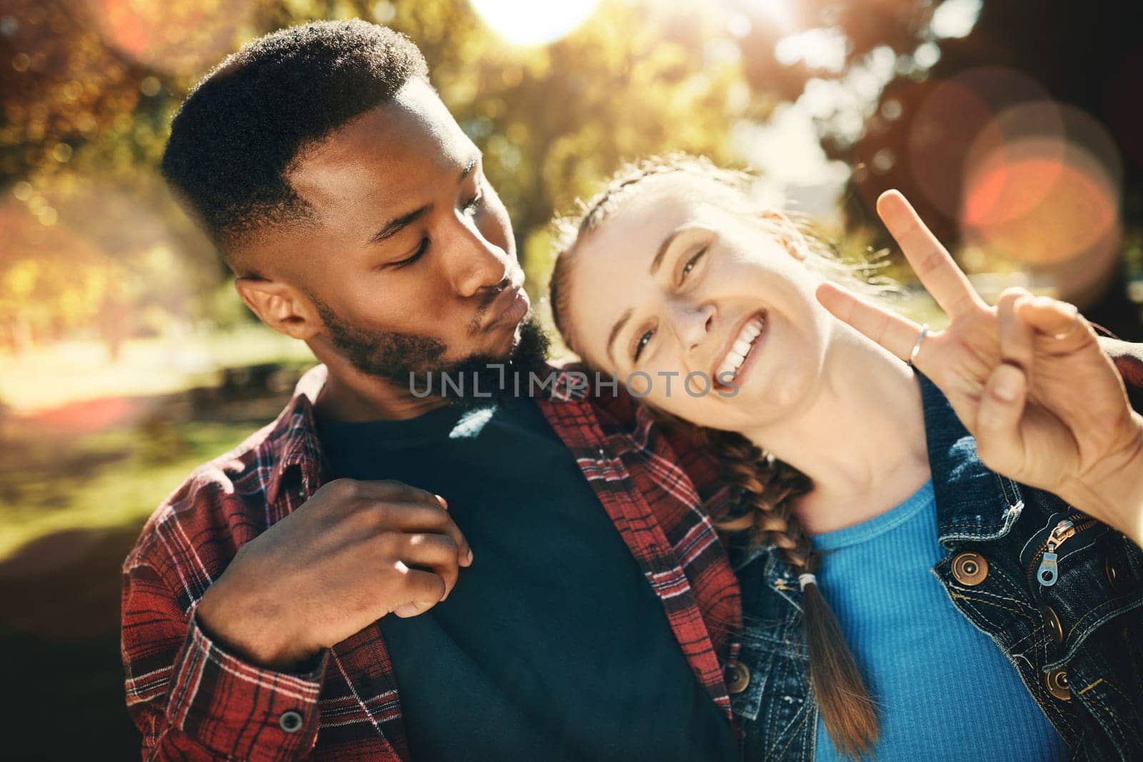 Couple, selfie peace sign and portrait smile outdoors, enjoying fun time and bonding at park. Interracial, love romance and black man and woman with v hand emoji for taking pictures for happy memory