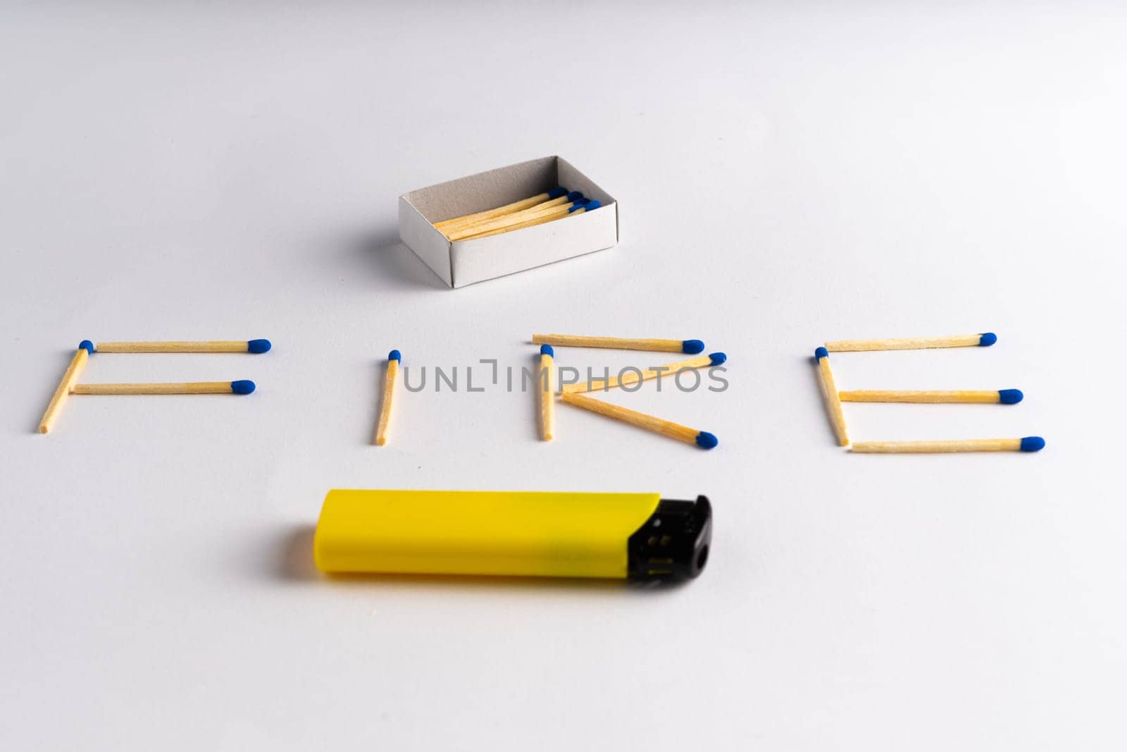 Lighter on a white background including matches box, word FIRE