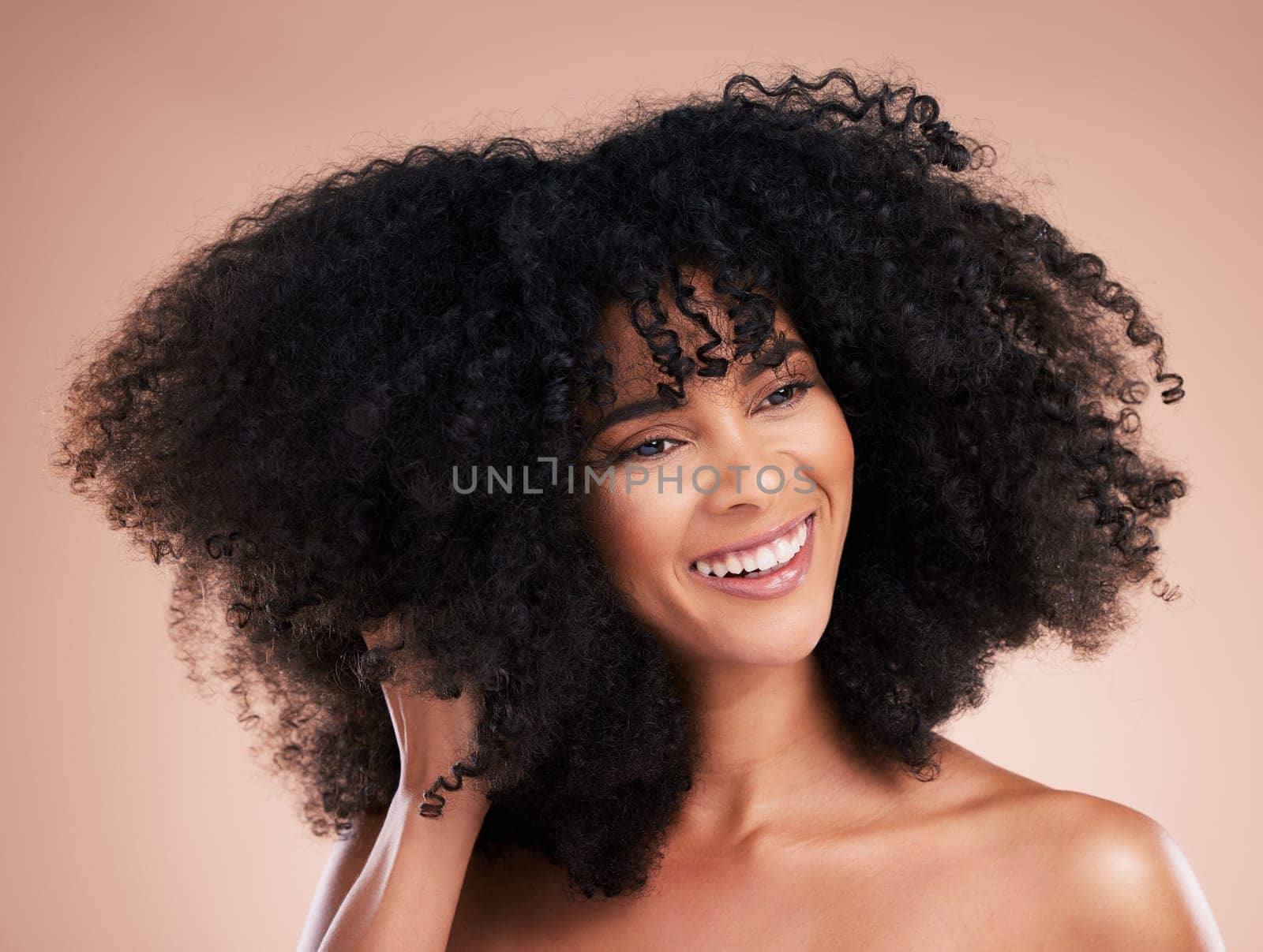 Hair care, black woman and curly texture of a young model with a healthy afro from salon treatment. Happy face, cosmetics and African person with wellness, skincare and smile from beauty in studio by YuriArcurs