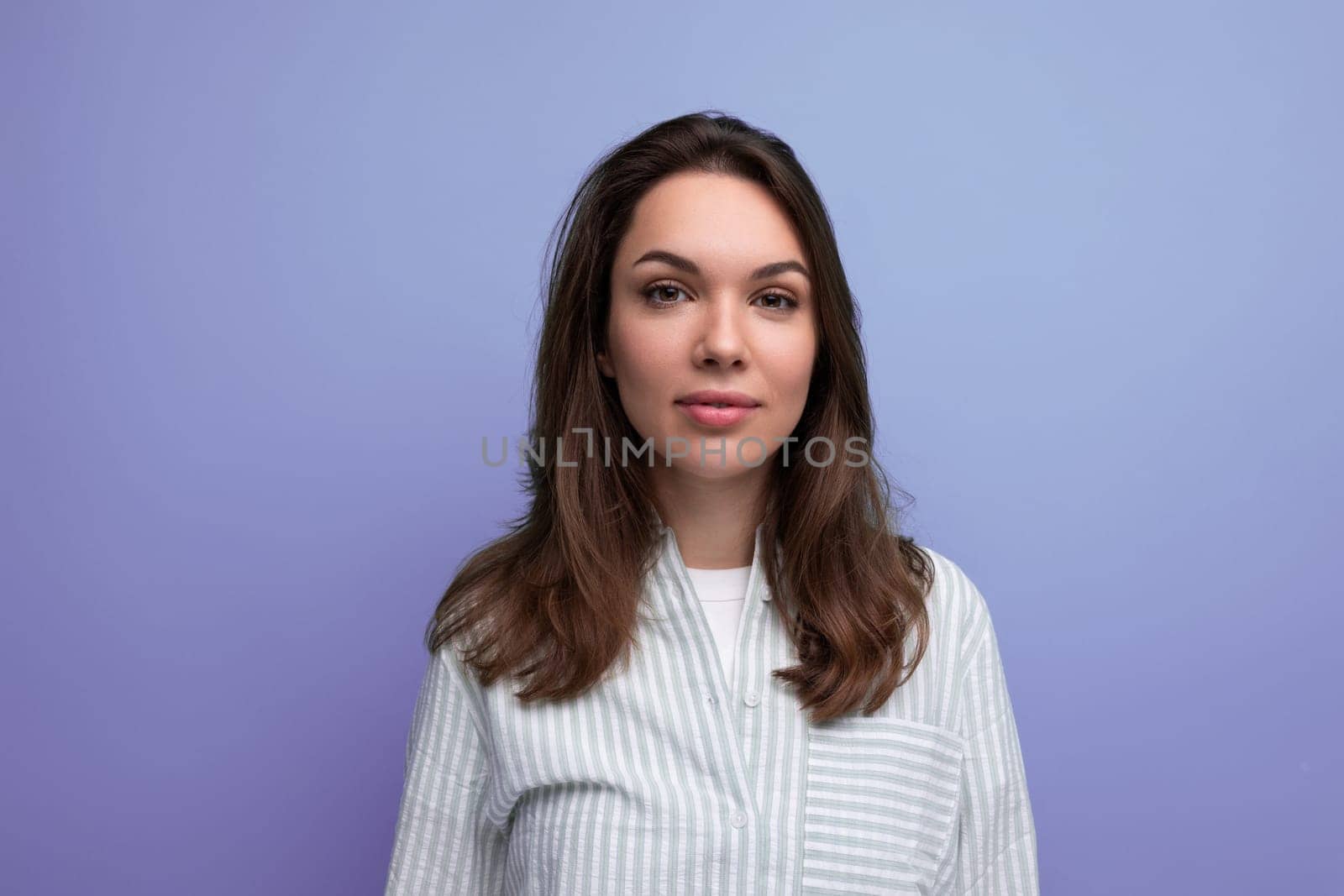 joyful 25 year old brown-haired woman with well-groomed silky hair after hairdresser work.