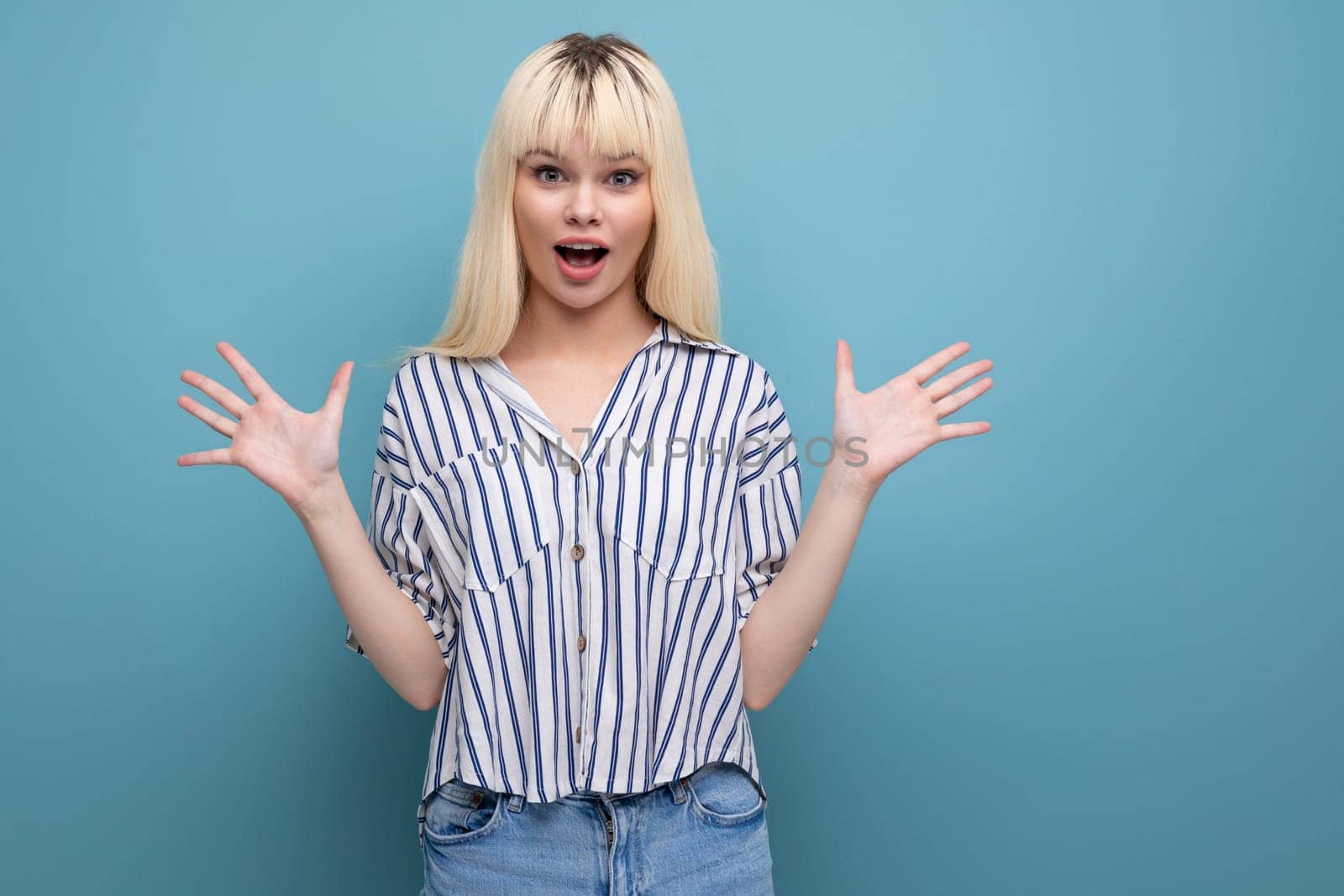 happy surprised blonde young female adult in blouse isolated background.