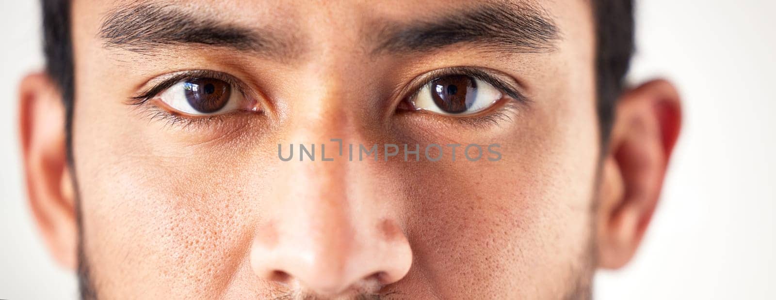 Closeup, portrait and man with eyes, vision and looking forward with sight, see and clear optics. Face, male person or model with eyesight, zoom or eyecare with health, wellness or staring with focus.