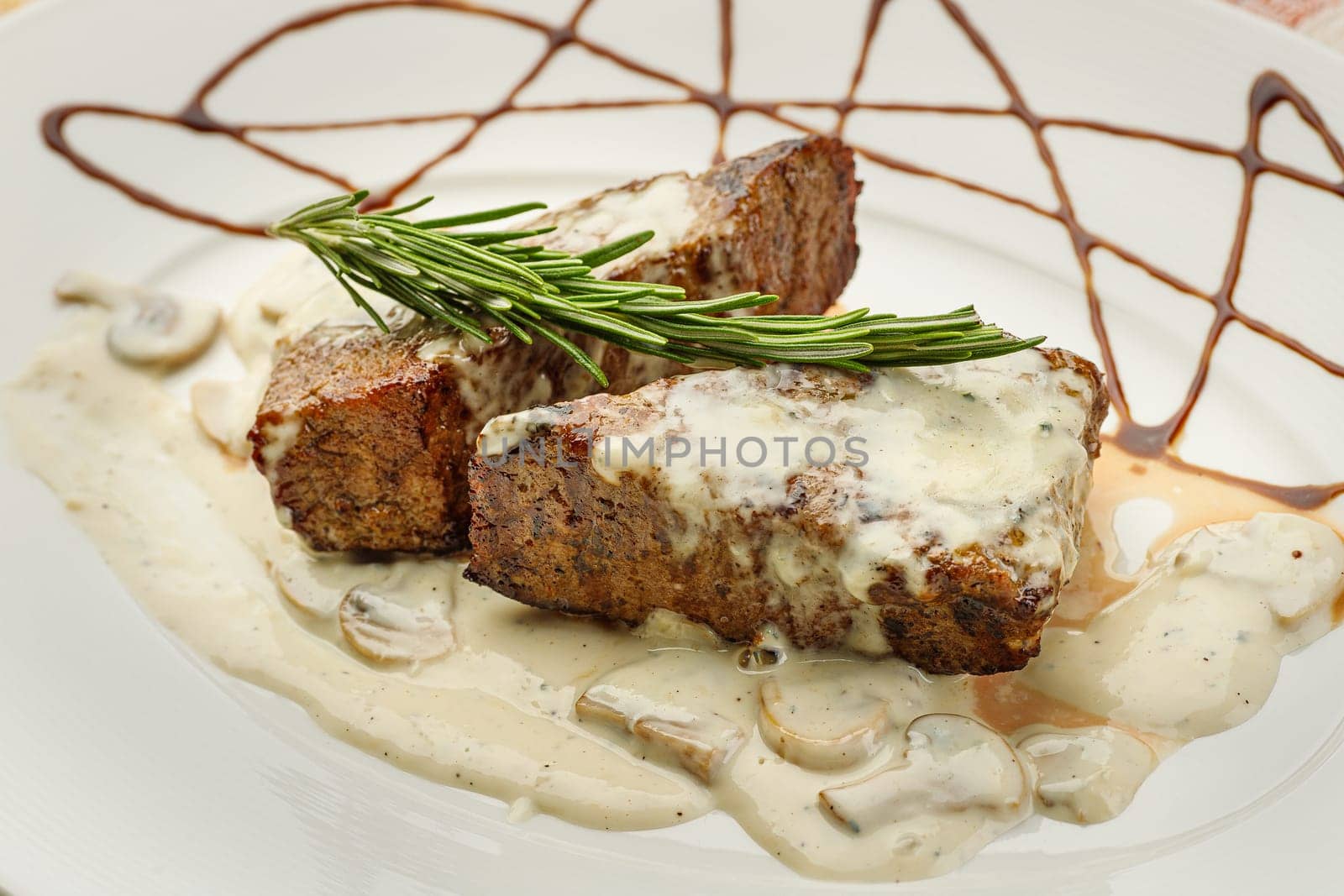 Gourmet thick juicy fillet steak medallions grilled to perfection and served topped with fried wild mushrooms and herbs